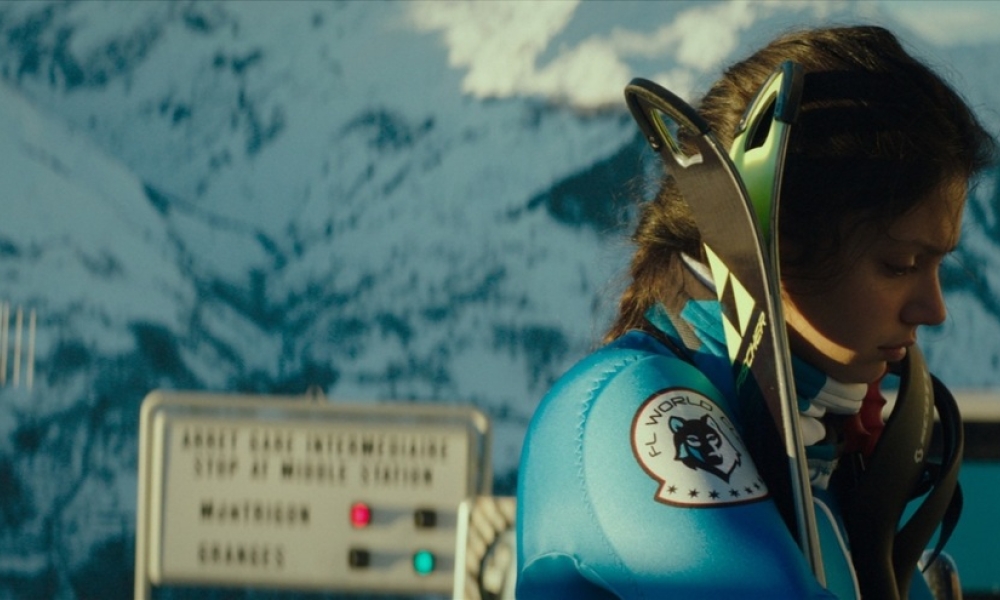 Frame de la película Slalom – Al límite, en el que una mujer vestida de azul mira hacia el suelo