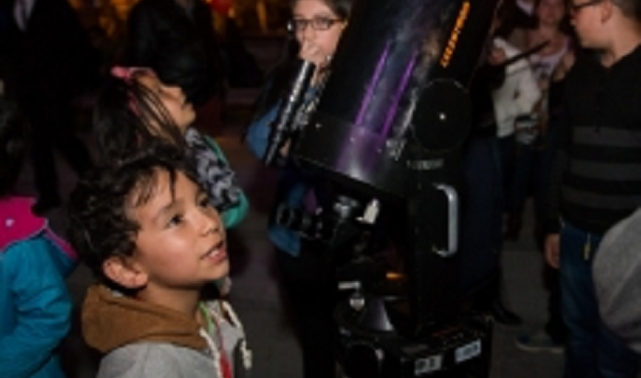 Personas participando de un ejercicio de observación nocturna con telescopio