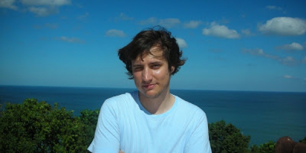 Hombre posando para la cámara frente al mar